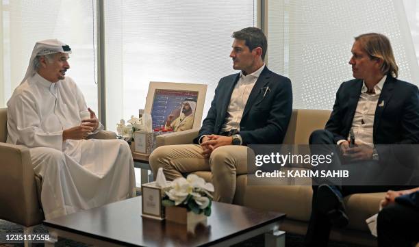 Secretary General of the Dubai Sports Council Mohammed Saeed Harib speaks with retired Spanish football player and goalkeeper Iker Casillas and...