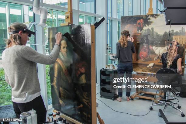 Conservators work on restoring damaged paintings ahead of the opening of the Netherlands' new combined national collection 'Collection Center...