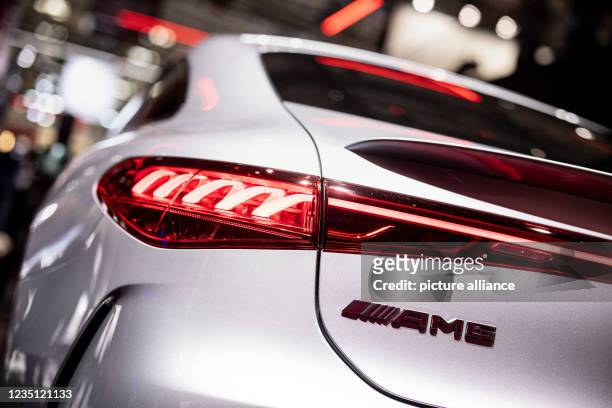 September 2021, Bavaria, Munich: The Mercedes-AMG GmbH logo can be seen on a Mercedes EQS at the Daimler AG stand during the International Motor Show...