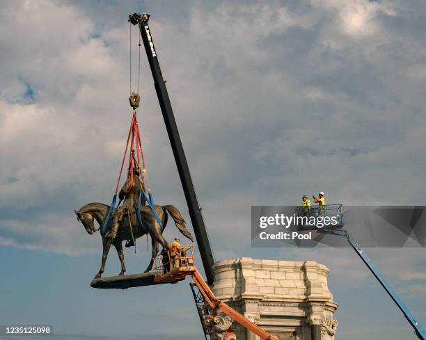 The statue of Robert E. Lee is lowered from its plinth at Robert E. Lee Memorial during its removal on September 8, 2021 in Richmond, Virginia. The...