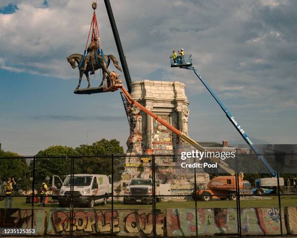 The statue of Robert E. Lee is lowered from its plinth at Robert E. Lee Memorial during its removal on September 8, 2021 in Richmond, Virginia. The...