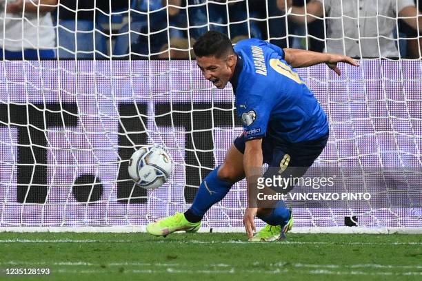 Italy's forward Giacomo Raspadori reacts after scoring his team's second goal during the FIFA World Cup Qatar 2022 Group C qualification football...