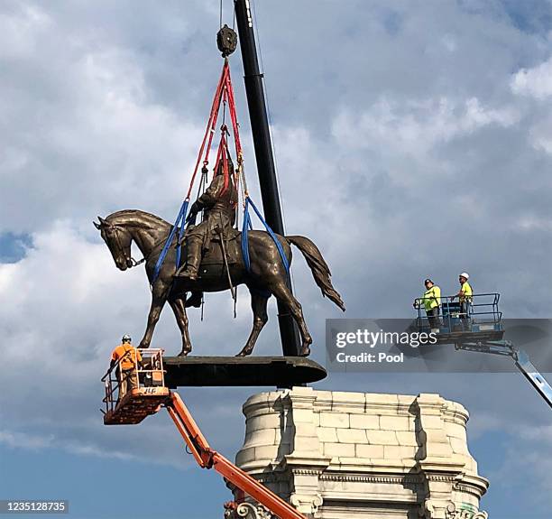 The statue of Confederate General Robert E. Lee is removed from its pedestal on Monument Avenue on September 8, 2021 in Richmond, Virginia. The...