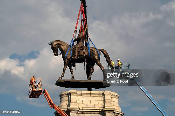 The statue of Confederate General Robert E. Lee is removed from its pedestal on Monument Avenue on September 8, 2021 in Richmond, Virginia. The...