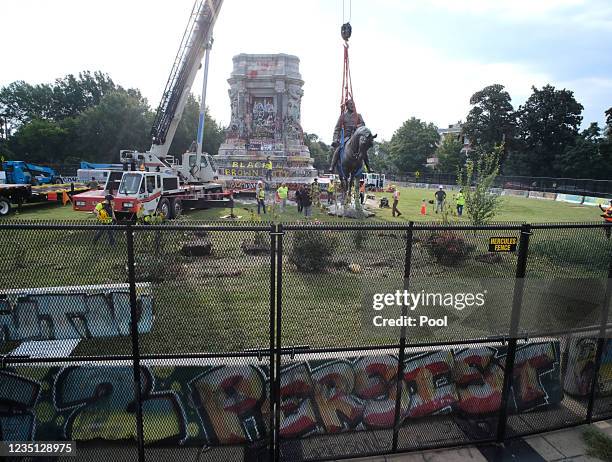 The statue of Confederate General Robert E. Lee is removed from its pedestal on Monument Avenue on September 8, 2021 in Richmond, Virginia. The...