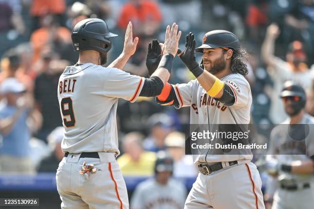 Brandon Crawford of the San Francisco Giants is congratulated by Brandon Belt after hitting a sixth inning 3-run home run against the Colorado...