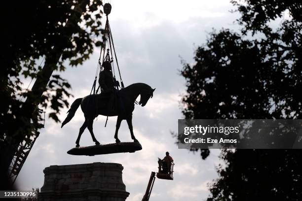 Workers remove the statue of Robert E. Lee at the Marcus-David Peters circle prior to its removal on September 8, 2021 in Richmond, Virginia. The...