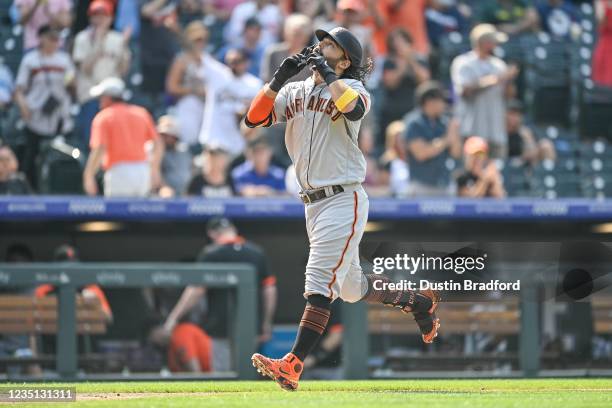 Brandon Crawford of the San Francisco Giants celebrates after hitting a sixth inning 3-run home run against the Colorado Rockies at Coors Field on...