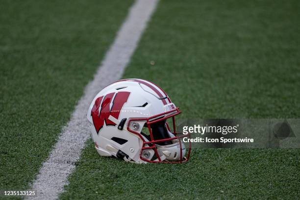 Wisconsin Badger football helmet sits on the field during warmups prior to a college football game between the Penn State Nittany Lions and the...