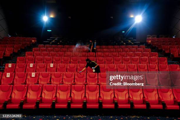 Employee disinfect and clean the seats inside a theater at a Golden Screen Cinemas multiplex cinema ahead of reopening in Kuala Lumpur, Malaysia, on...