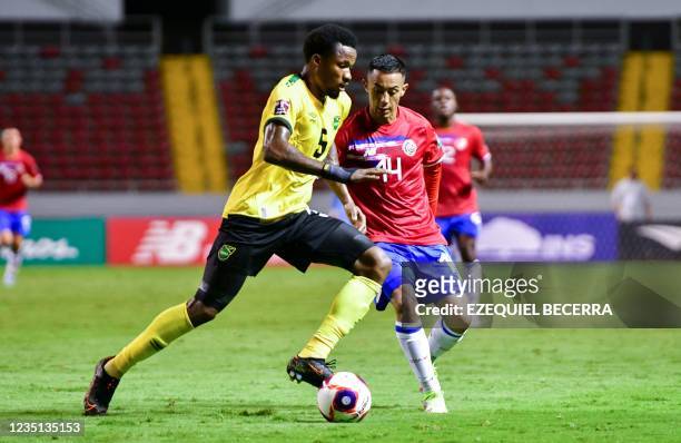 Jamaica's Nestor Alvas Powell vies for the ball with Costa Rica's Jimmy Marin during their Qatar 2022 FIFA World Cup Concacaf qualifier match at the...