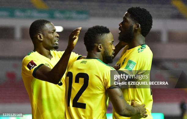 Jamaica's Shamar Nicholson celebrates with teammates Cory Burke and Junior Flemmings after scoring against Costa Rica during their Qatar 2022 FIFA...