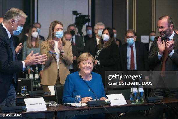 Chairman of the center-right European People Party group Manfred Weber and Popular Party's Deputy Secretary Esteban Gonzalez Pons applaud German...