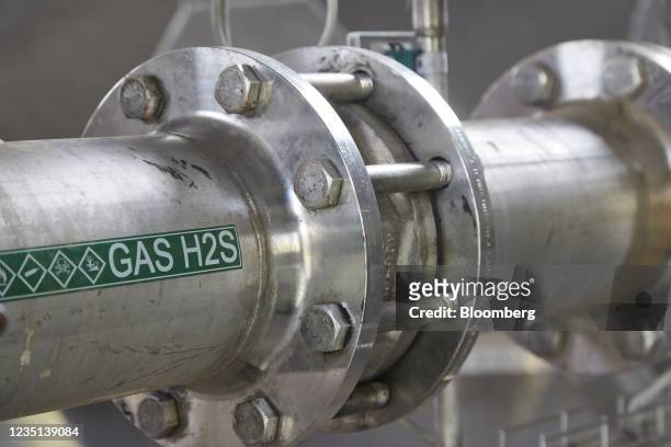 Gas H2S' sign on pipework used for storing carbon dioxide underground in a pod, operated by Carbfix, in Hellisheidi, Iceland, on Tuesday, Sept. 7,...