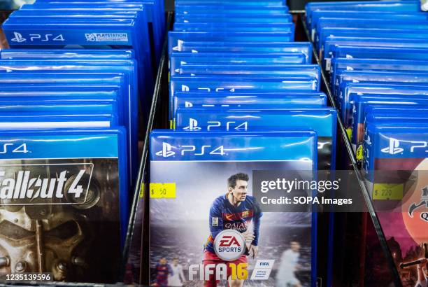 Shop sells EA SPORTS FIFA football game displaying Argentinian football player Lionel Messi still wearing football club Barcelona jersey from the...