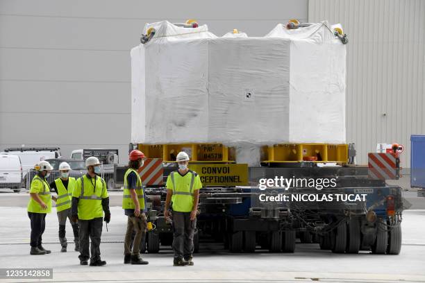 Engineers stand next to the world's most powerful magnet as it is delivered at the international nuclear fusion project Iter in...