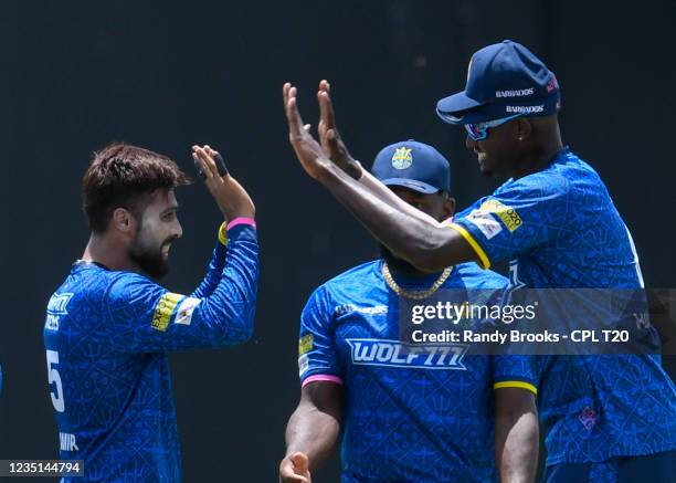 Mohammad Amir and Jason Holder of Barbados Royals celebrates the dismissal of Lendl Simmons of Trinbago Knight Riders during the 2021 Hero Caribbean...