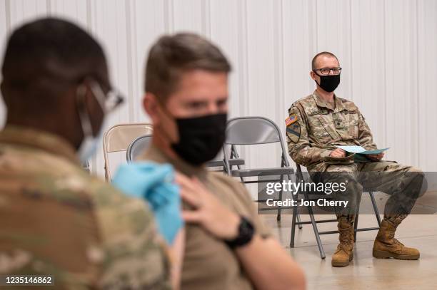Soldier watches another soldier receive his COVID-19 vaccination from Army Preventative Medical Services on September 9, 2021 in Fort Knox, Kentucky....