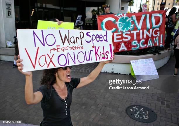 Demonstrators opposed to masking and mandatory vaccination for students gather outside the Los Angeles Unified School District headquarters as board...