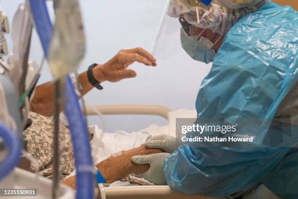 Nurse in the COVID-19 Intensive Care Unit at Three Rivers Asante Medical Center speaks with a patient on September 9, 2021 in Grants Pass, Oregon....