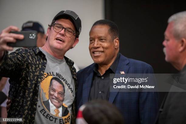 Johnny Marin takes a photo with Republican recall candidate Larry Elder at a Latino town hall event at the New Season LA Church as Elder campaigns to...