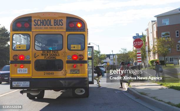 Students wearing face masks get on a school bus in Mississauga, the Greater Toronto Area, Ontario, Canada, on Sept. 9, 2021. Schools in Toronto,...