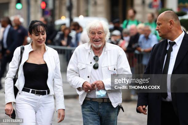 French singer Hugues Aufray arrives with his partner Muriel at the funeral ceremony for late French actor Jean-Paul Belmondo at the...