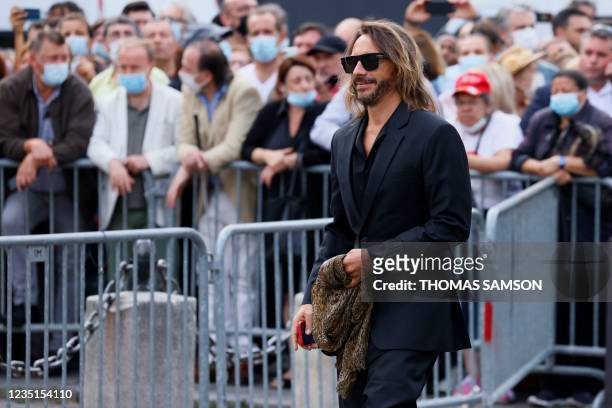 French producer and house music DJ Christophe Le Friant, known as Bob Sinclar arrives for the funeral ceremony for late French actor Jean-Paul...