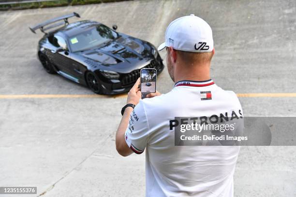 Valtteri Bottas , Mercedes-AMG Petronas Formula One Team takes a mobile phone photo of the Mercedes-AMG Black Series on the old track with the steep...