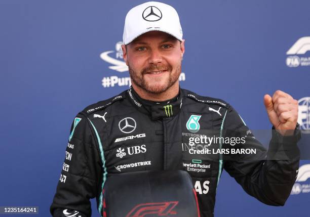 Mercedes' Finnish driver Valtteri Bottas poses in the parc ferme after the qualifying sessions at the Autodromo Nazionale circuit in Monza, on...