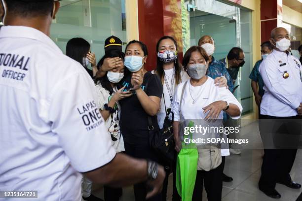 Relatives of the victims who died in a fire at the Tangerang prison mourn in front of the mortuary of the National Police Hospital. Currently there...