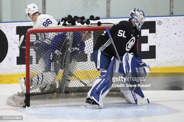Toronto, ON- September 10 - Goaltender Erik Kallgren watches as pucks on the net go flying as Ryan Chyzowski checks Bretr Budgell. The Toronto Maple...