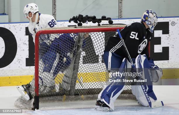 Toronto, ON- September 10 - Goaltender Erik Kallgren watches as pucks on the net go flying as Ryan Chyzowski checks Bretr Budgell. The Toronto Maple...