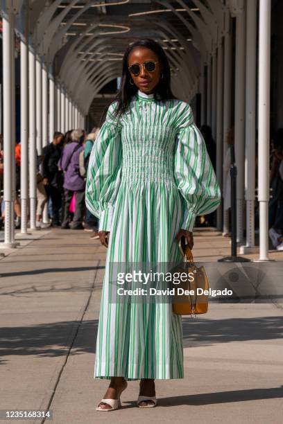 Aissata Kourouma is seen wearing a dress by Ganni with a hand bag and shoes by Zara at Spring Studios during New York Fashion Week on September 10,...