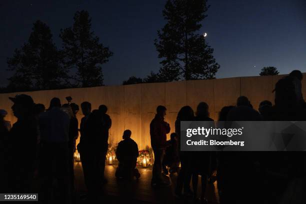 Attendees are silhouetted during a Luminaria Ceremony at Flight 93's Memorial Plaza ahead of the 20th anniversary of the 9/11 attacks in Shanksville,...