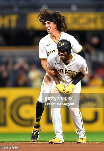 Ke'Bryan Hayes of the Pittsburgh Pirates celebrates with Cole Tucker after hitting a game-winning RBI single during the ninth inning against the...