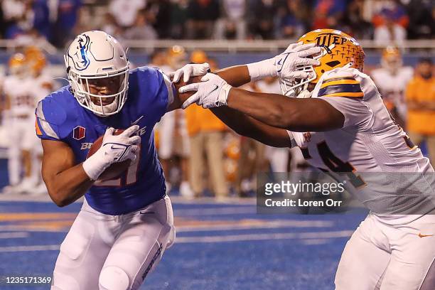 Running back Andrew Van Buren of the Boise State Broncos stiff arms defensive back McKel Broussard of the UTEP Miners during the second half at...