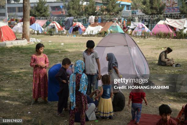 Internally displaced children gather near their makeshift campsite during a free medical camp at Shahr-e-Naw Park in Kabul on september 11, 2021.