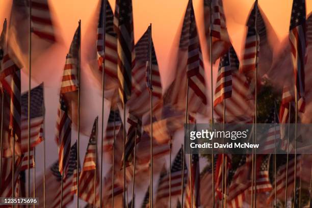 Flags are displayed during the 14th annual Waves of Flags on the eve of the 20th anniversary of the September 11 terror attacks in Alumni Park at...