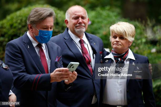 American Airlines flight crew pay their respects at the September 11 Memorial Garden at Grosvenor Square on September 11, 2021 in London, England....