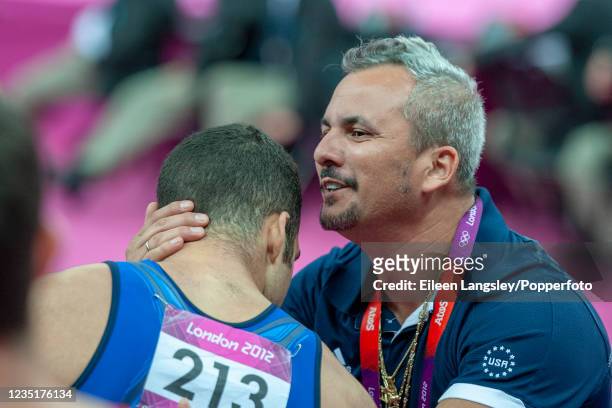 Danell Leyva representing the United States is encouraged by his coach and stepfather Yin Alvarez before he competes on floor in the mens artistic...