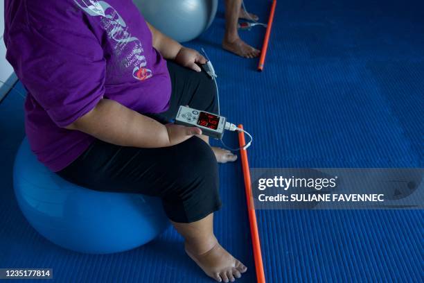 Patient who was infected with Covid-19 and went into intensive care sits with a tension metre at the ORA ORA follow-up care and rehabilitation centre...