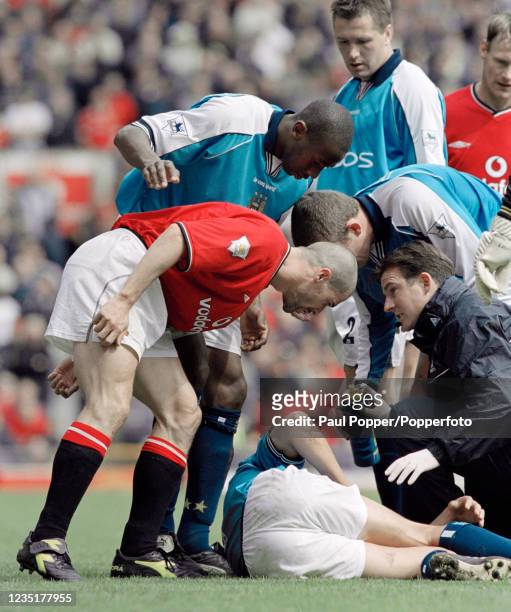 Roy Keane of Manchester United has a few words for Alf-Inge Haaland of Manchester City after being sent-off for the challenge that broke Haaland's...