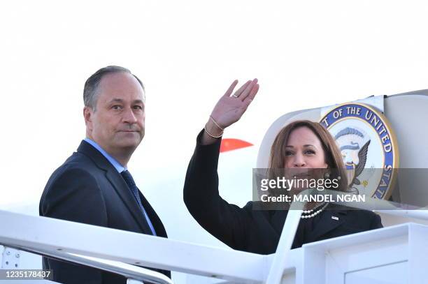 Vice President Kamala Harris and her husband Doug Emhoff make their way to board a flight before departing from Andrews Air Force Base in Maryland on...