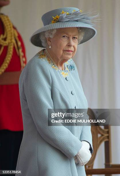 In this file photo taken on June 12 Britain's Queen Elizabeth II watches a military ceremony to mark her official birthday in Windsor. - Queen...