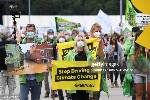Greenpeace activists protest against the International Motor Show at the Theresienwiese in Munich, southern Germany, on September 11, 2021.