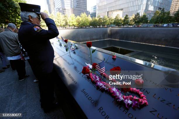 Member of the FDNY visits the reflecting pool during a ceremony at the National September 11 Memorial & Museum commemorating the 20th anniversary of...