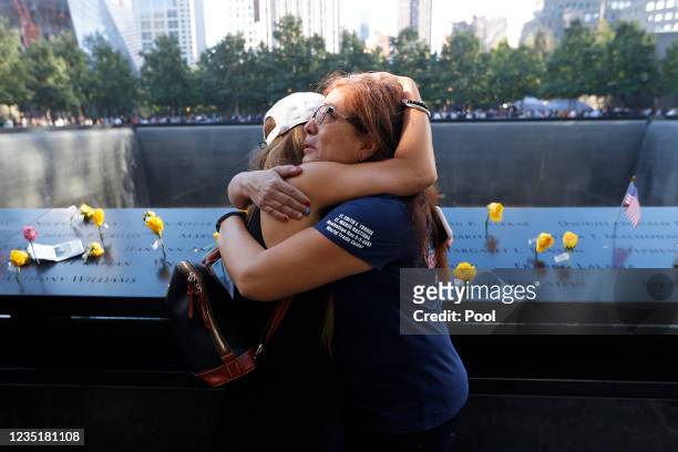 Melinda Moran and Haydee Lillo embrace after finding out they lost people who knew each other, next to the North Reflecting Pool during a ceremony at...