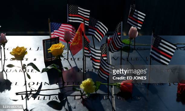 Flags and flowers adorn the National 9/11 Memorial and Museum during the ceremony commemorating the 20th anniversary of the 9/11 attacks on the World...
