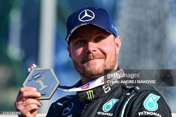 Mercedes' Finnish driver Valtteri Bottas celebrates with his medal after placing first in the sprint session at the Autodromo Nazionale circuit in...